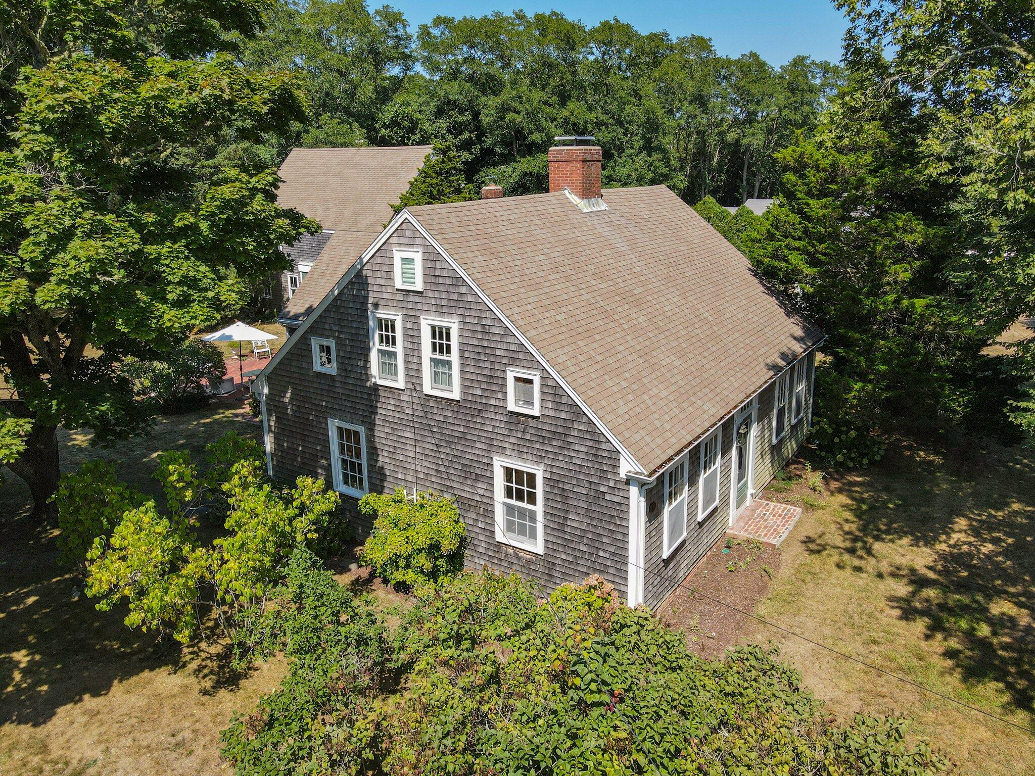 1955 Bridge Road Eastham, MA 02642 - Photo 56 of 77 a aerial view of a house with yard and trees in the background