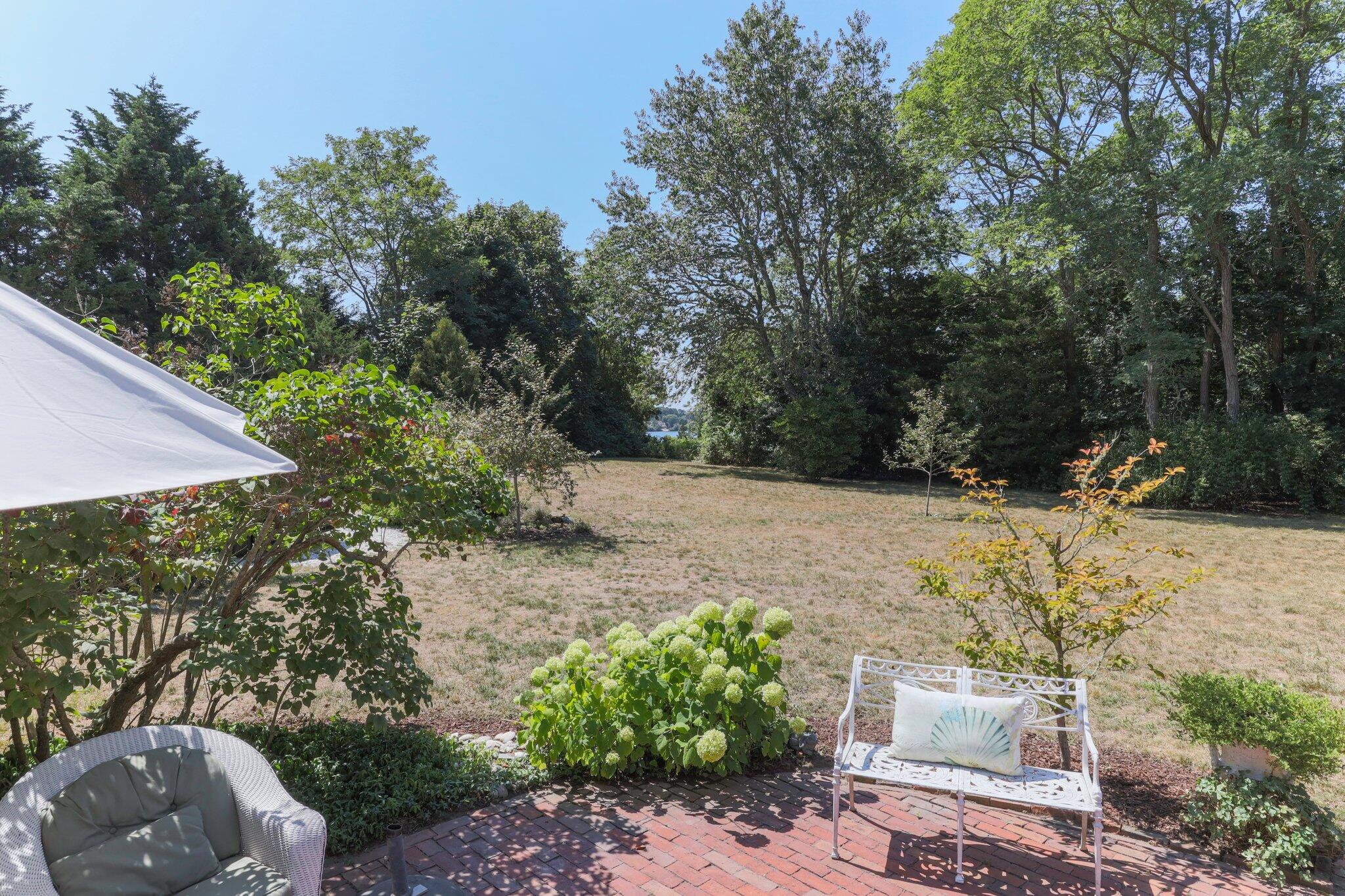 1955 Bridge Road Eastham, MA 02642 - Photo 71 of 77 a view of backyard with table and chairs and potted plants