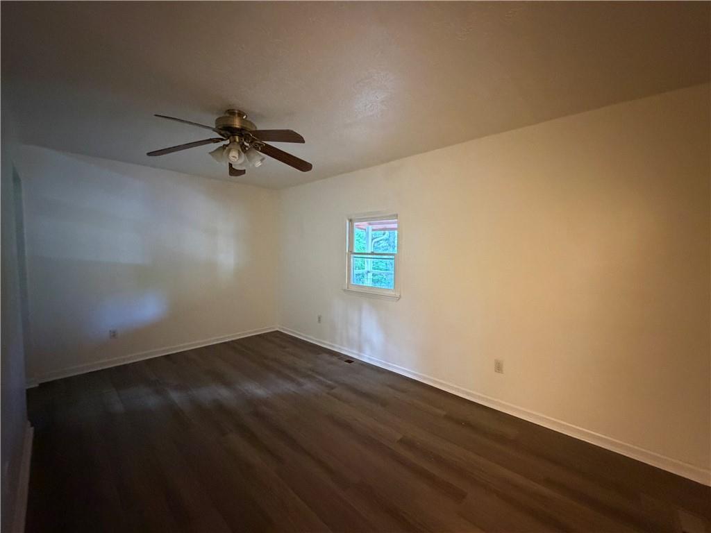 86 Robert Jones Road Dawsonville, GA 30534 - Photo 9 of 19 an empty room with wooden floor and windows