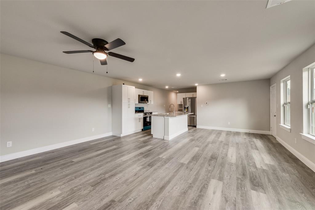 3153 Stag Road Dallas, TX 75241 - Photo 4 of 15 a view of empty room with wooden floor and window