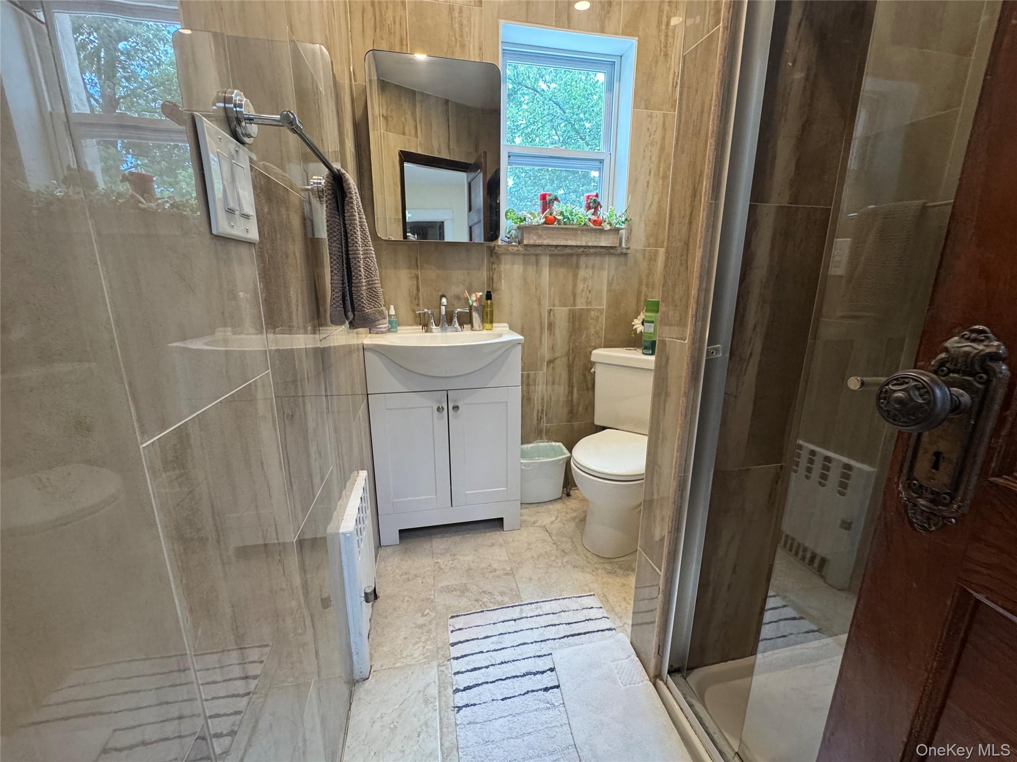 80-58 88th Road Queens, NY 11421 - Photo 11 of 21 a bathroom with a sink toilet and shower