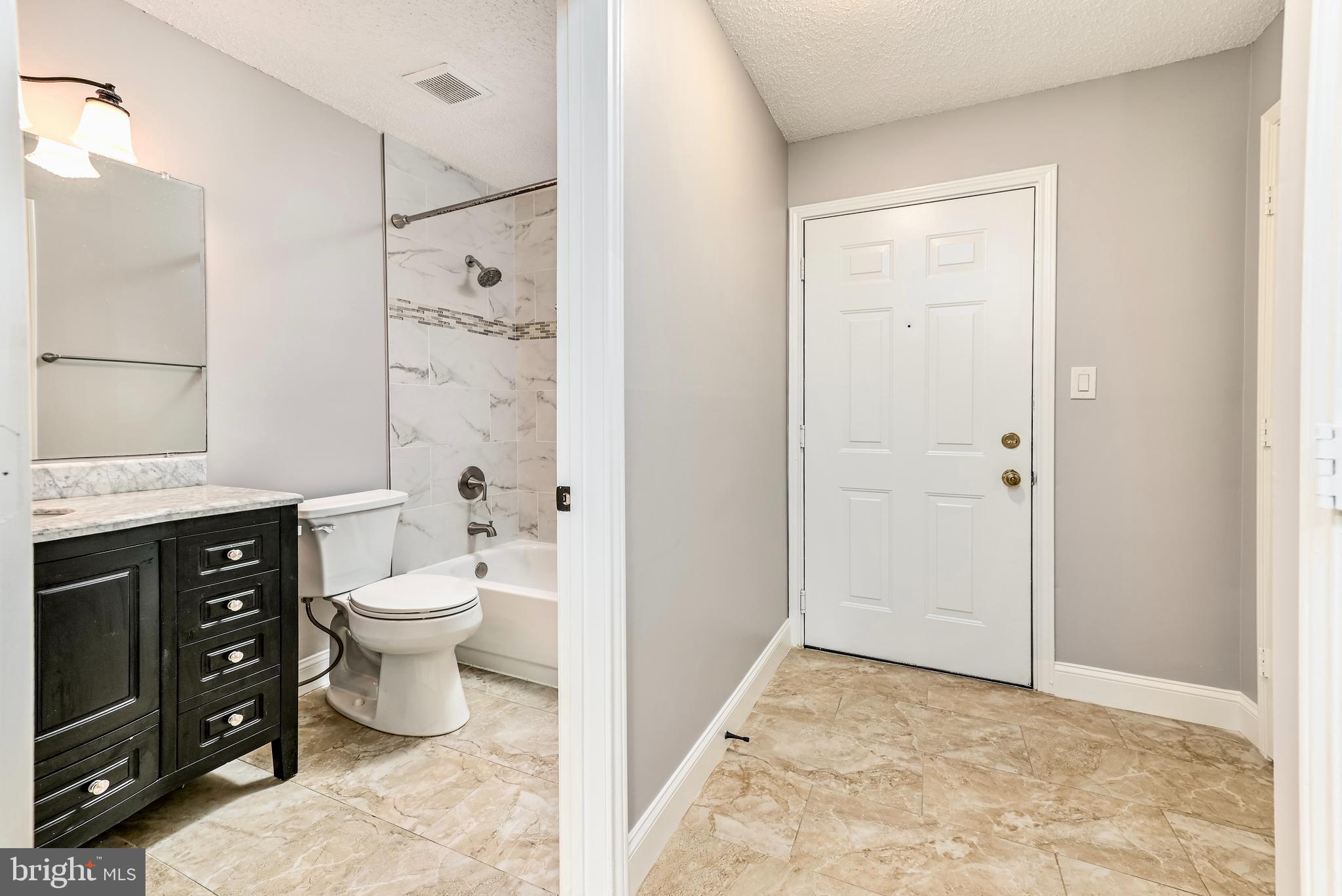 20991 Timber Ridge Terrace, Unit 204 Ashburn, VA 20147 - Photo 15 of 27 Master Bath with granite counter and Tile