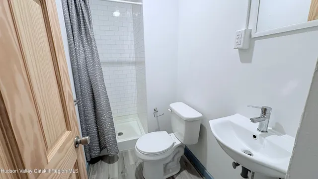 a white toilet sitting next to a bathroom sink