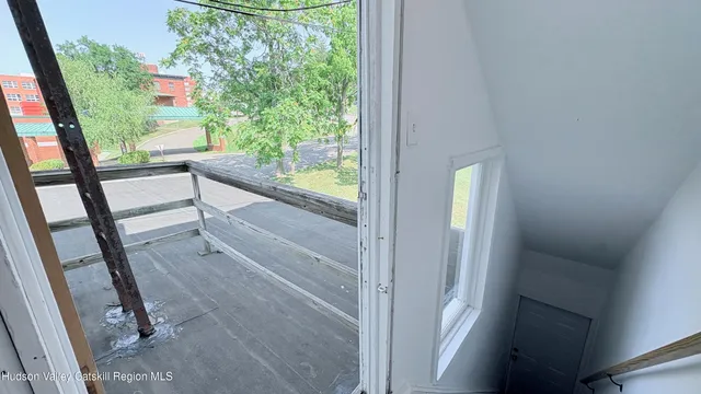a view of a balcony with wooden floor