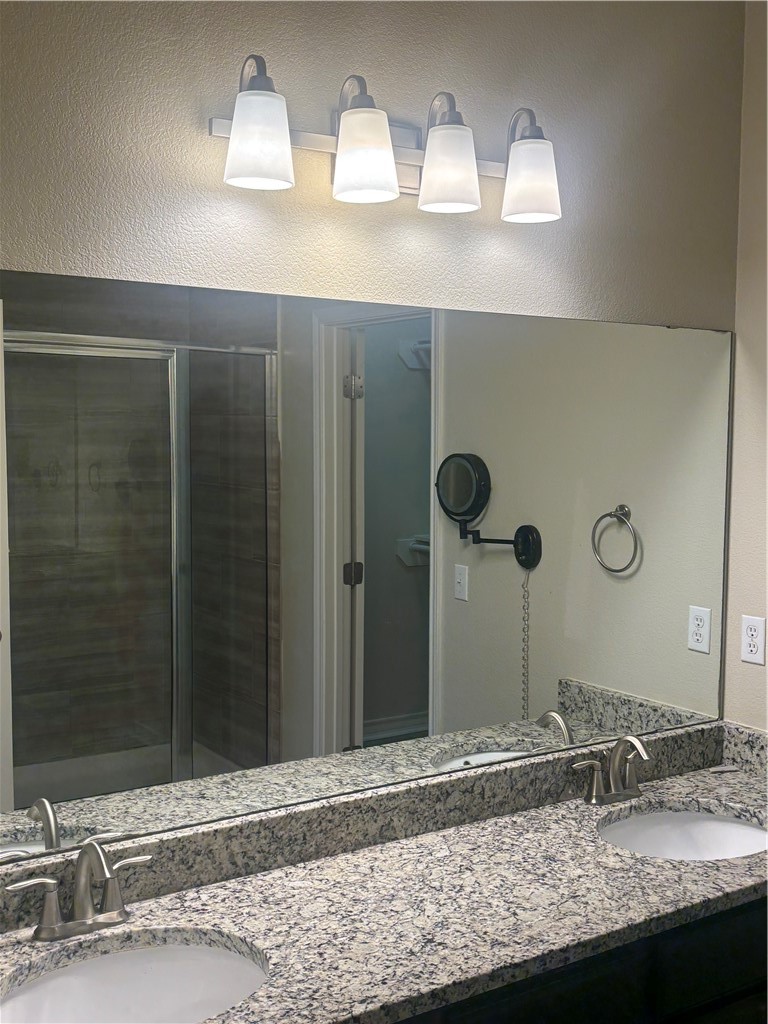 921 Moore Avenue Portland, TX 78374 - Photo 13 of 18 a bathroom with a granite countertop sink and a mirror