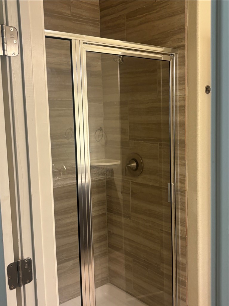 921 Moore Avenue Portland, TX 78374 - Photo 14 of 18 a bathroom with a glass door shower