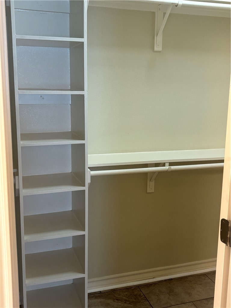 921 Moore Avenue Portland, TX 78374 - Photo 15 of 18 a view of walk in closet with empty racks
