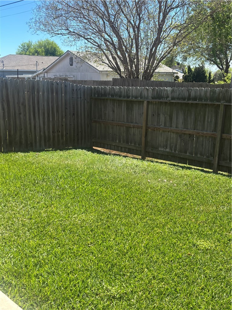 921 Moore Avenue Portland, TX 78374 - Photo 17 of 18 a view of a backyard with a small cabin