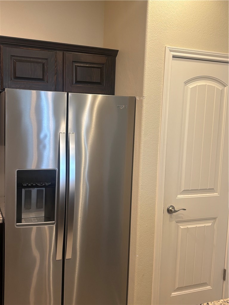 921 Moore Avenue Portland, TX 78374 - Photo 6 of 18 a metallic refrigerator freezer sitting inside of a kitchen