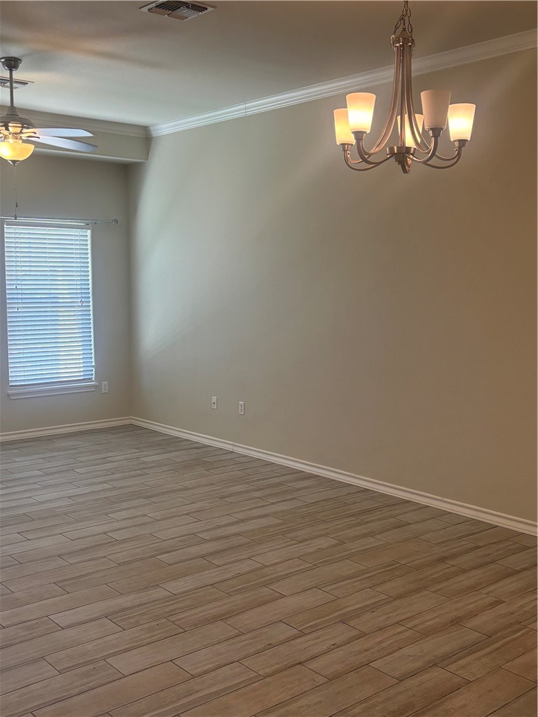 921 Moore Avenue Portland, TX 78374 - Photo 8 of 18 a view of an empty room with wooden floor and a window