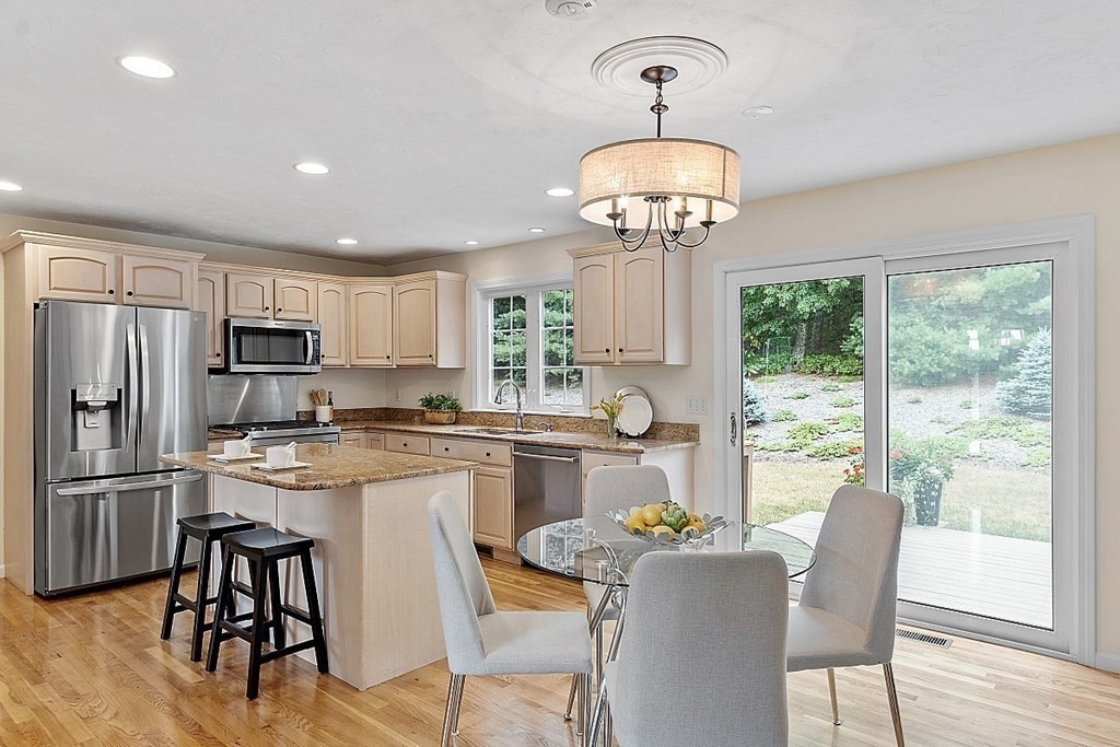 12 Whitetail Way Littleton, MA 01460 - Photo 11 of 39 a kitchen with microwave a refrigerator and chairs