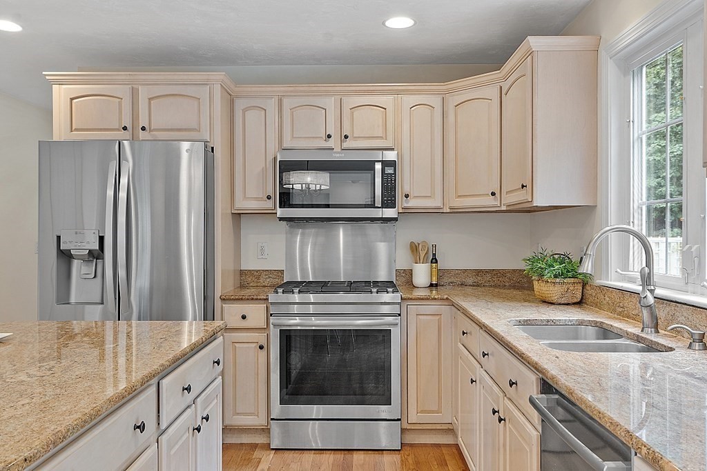 12 Whitetail Way Littleton, MA 01460 - Photo 12 of 39 a kitchen with granite countertop a stove sink and refrigerator