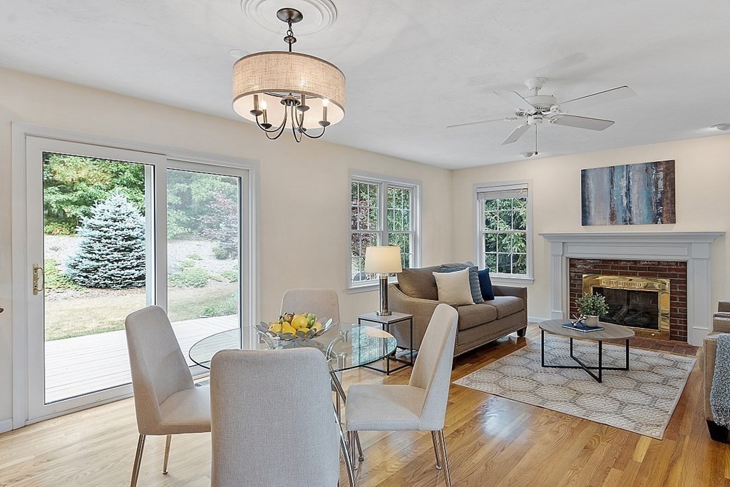 12 Whitetail Way Littleton, MA 01460 - Photo 13 of 39 a living room with furniture a chandelier and a fireplace