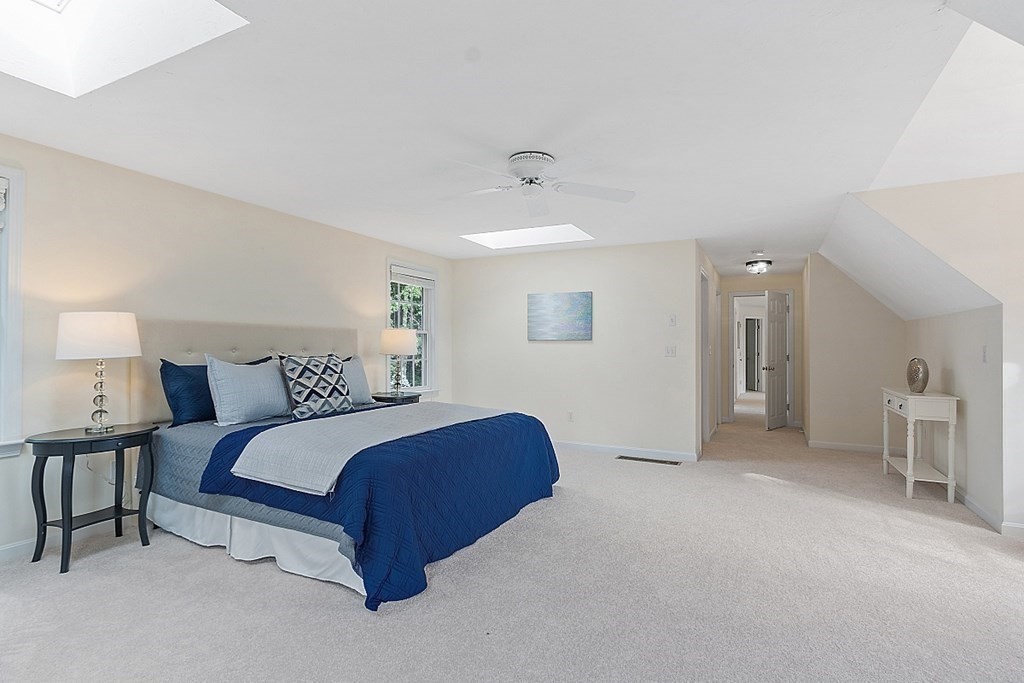 12 Whitetail Way Littleton, MA 01460 - Photo 19 of 39 a spacious bedroom with a bed and a lamp