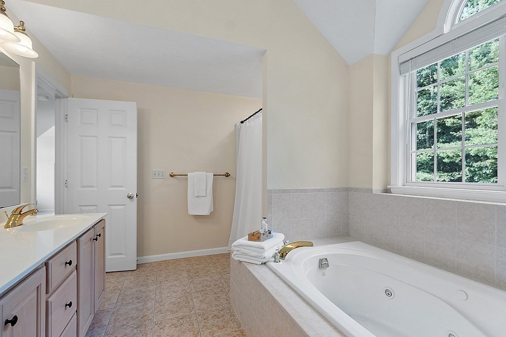 12 Whitetail Way Littleton, MA 01460 - Photo 24 of 39 a bathroom with a tub sink and mirror