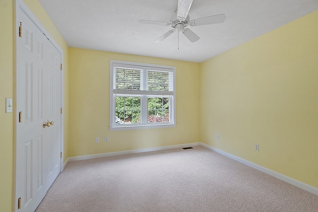 12 Whitetail Way Littleton, MA 01460 - Photo 27 of 39 an empty room with a window and a ceiling fan