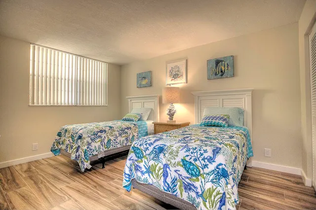 a bedroom with two beds and a dresser