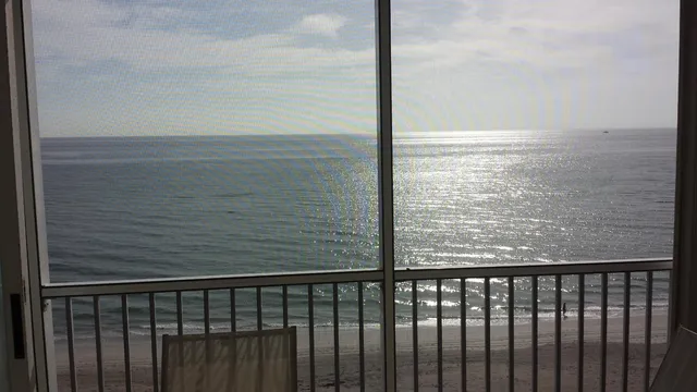 a view of a balcony next to a yard