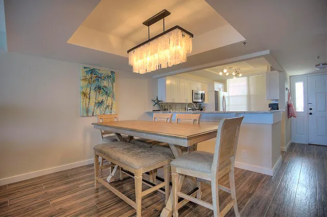 a view of a dining room with furniture and a chandelier