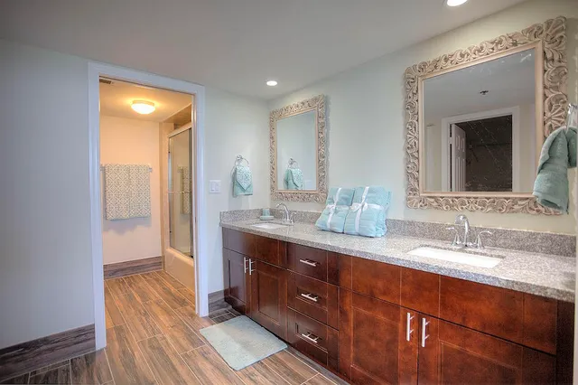 a bathroom with a double vanity sink and a mirror
