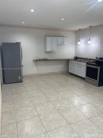 a kitchen with a stove and cabinets