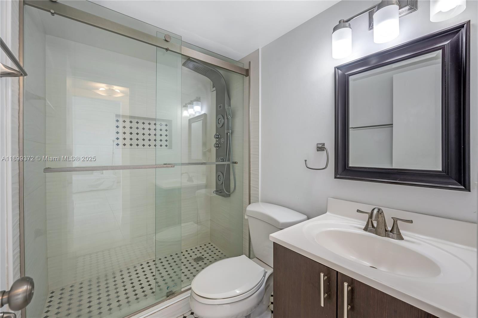 2750 Northeast 183rd Street, Unit 804 Aventura, FL 33160 - Photo 11 of 15 a bathroom with a sink a toilet and shower