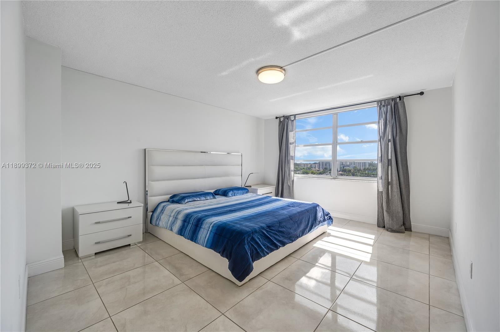 2750 Northeast 183rd Street, Unit 804 Aventura, FL 33160 - Photo 12 of 15 a room with a bed and a window