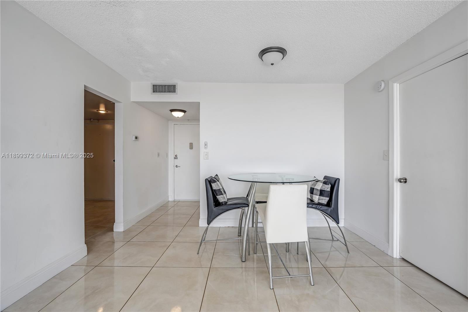 2750 Northeast 183rd Street, Unit 804 Aventura, FL 33160 - Photo 6 of 15 a dining room with furniture and wooden floor