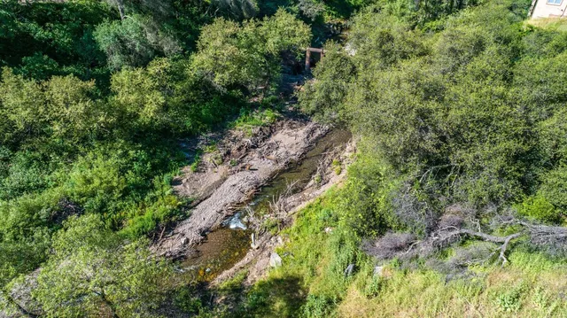 an aerial view of a houses with a yard