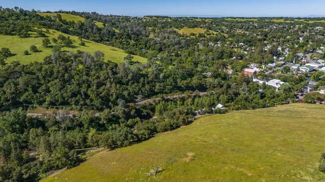 an aerial view of a residential houses with outdoor space
