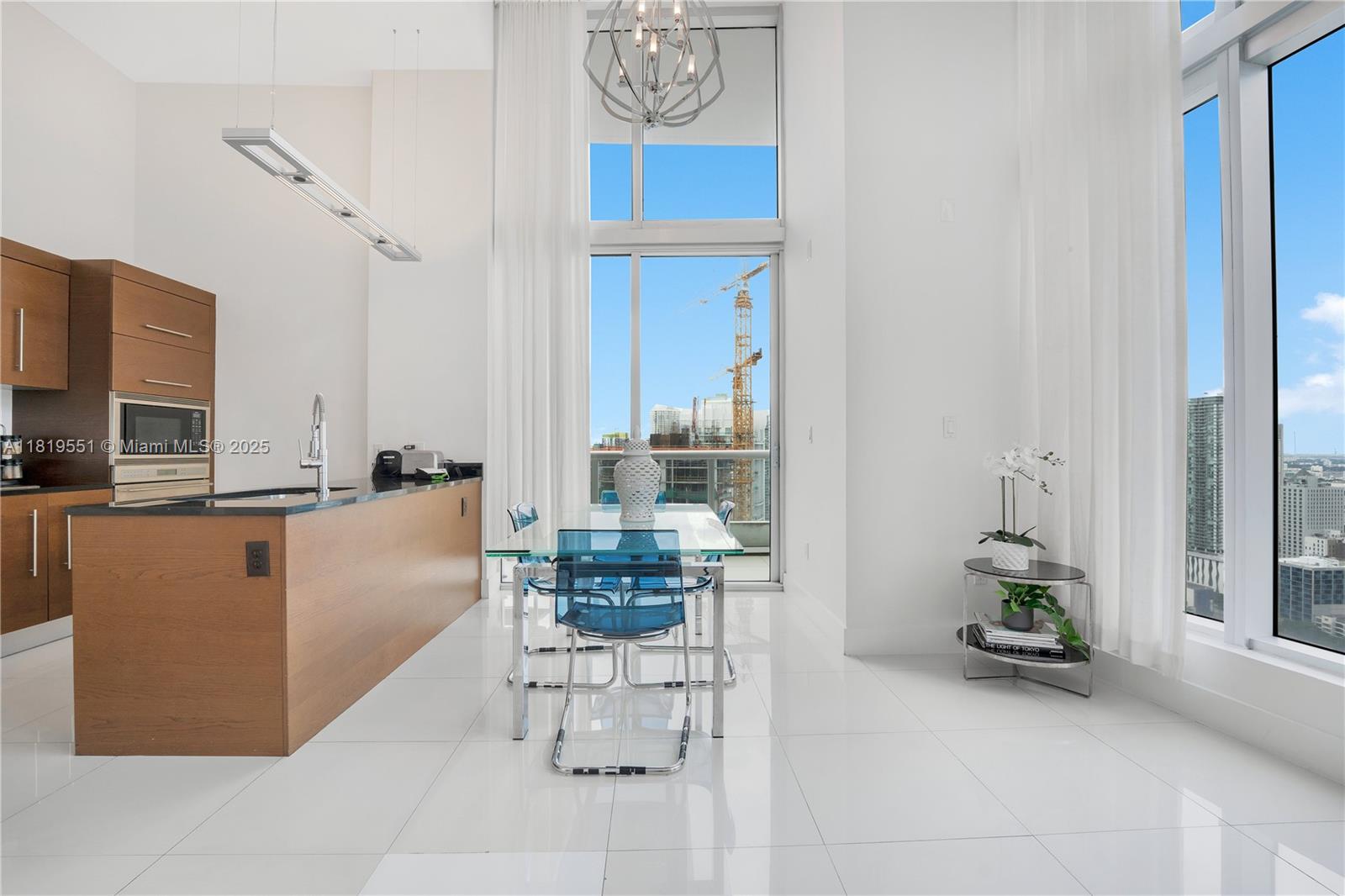 485 Brickell Avenue, Unit 4004 Miami, FL 33131 - Photo 11 of 22 a dining room with furniture and a window