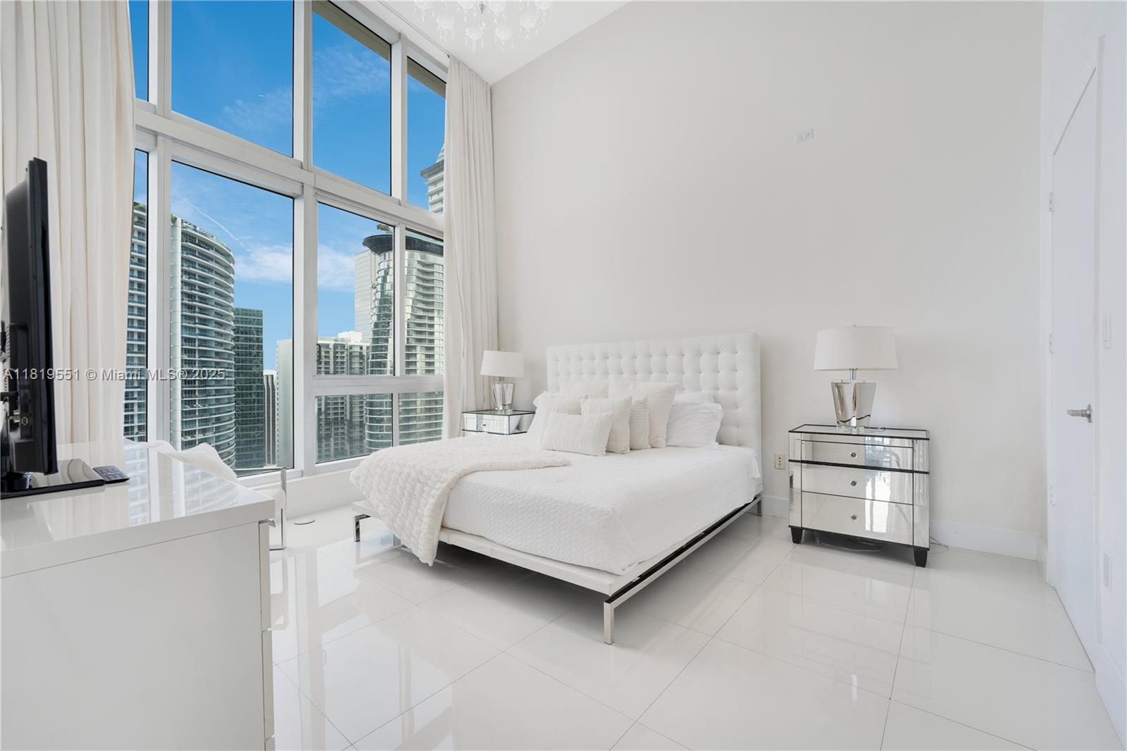 485 Brickell Avenue, Unit 4004 Miami, FL 33131 - Photo 12 of 22 a room with a bed and a large window
