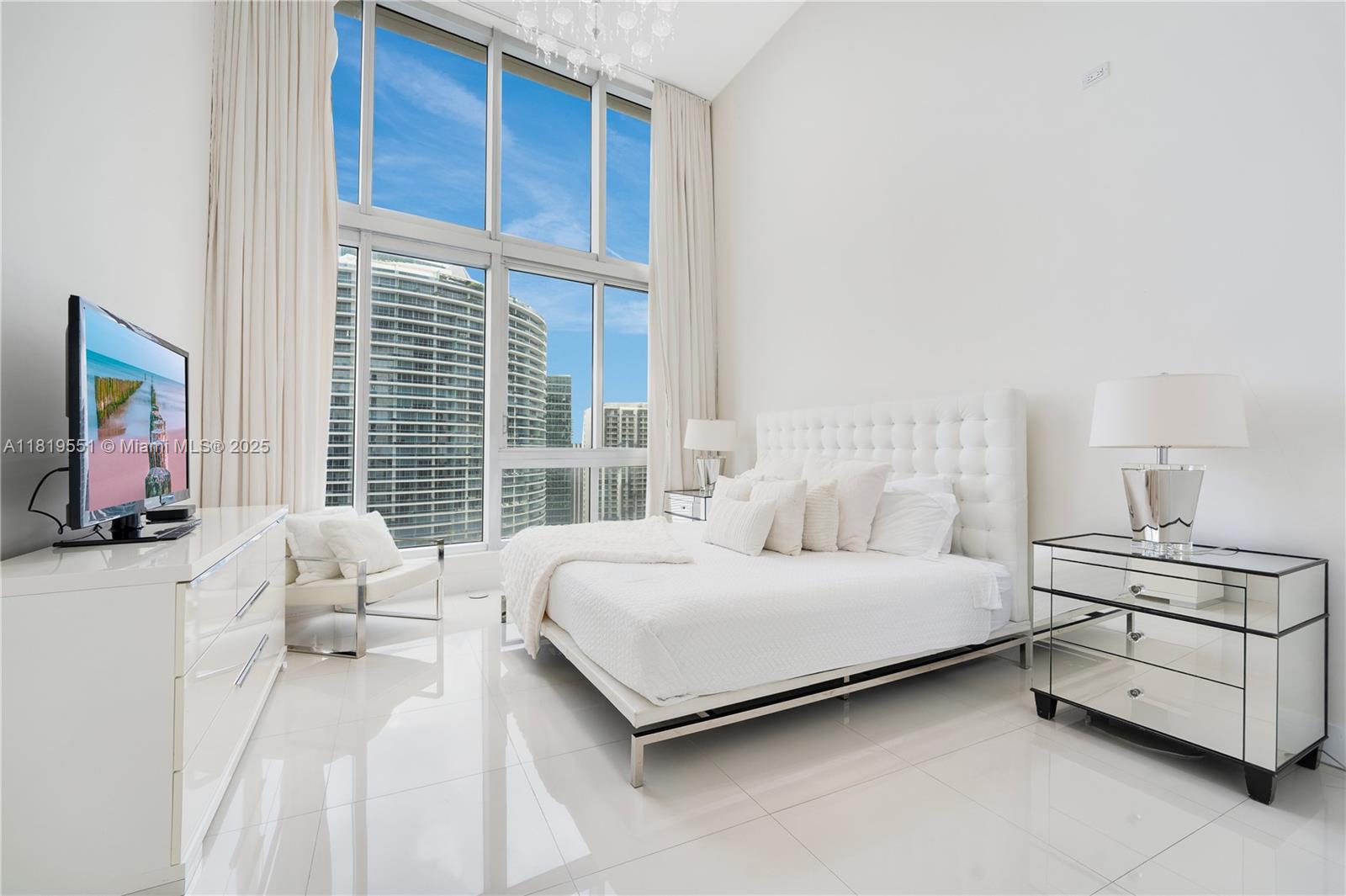 485 Brickell Avenue, Unit 4004 Miami, FL 33131 - Photo 17 of 22 a bedroom with a bed chair and window