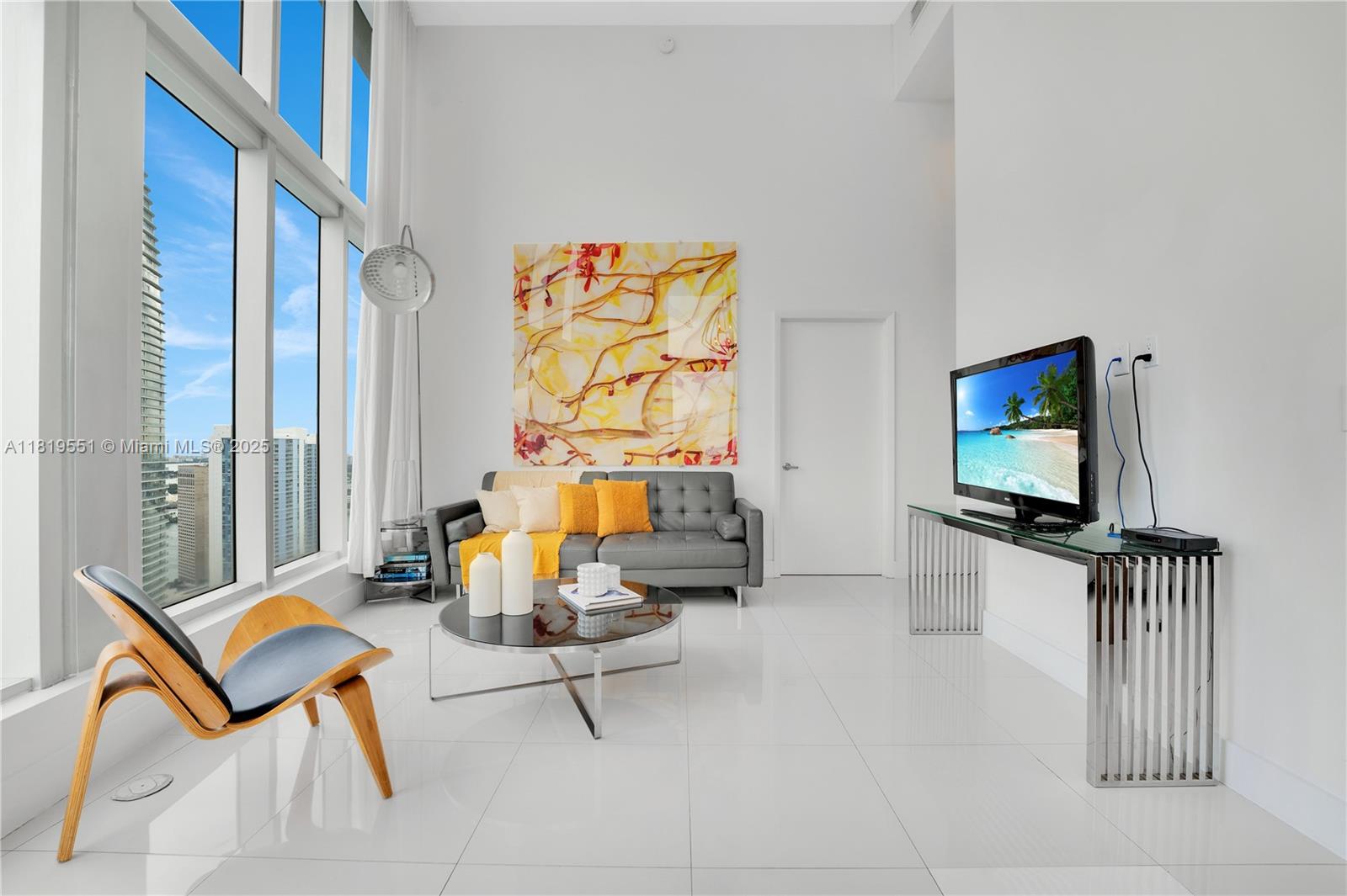 485 Brickell Avenue, Unit 4004 Miami, FL 33131 - Photo 2 of 22 a living room with furniture and a flat screen tv