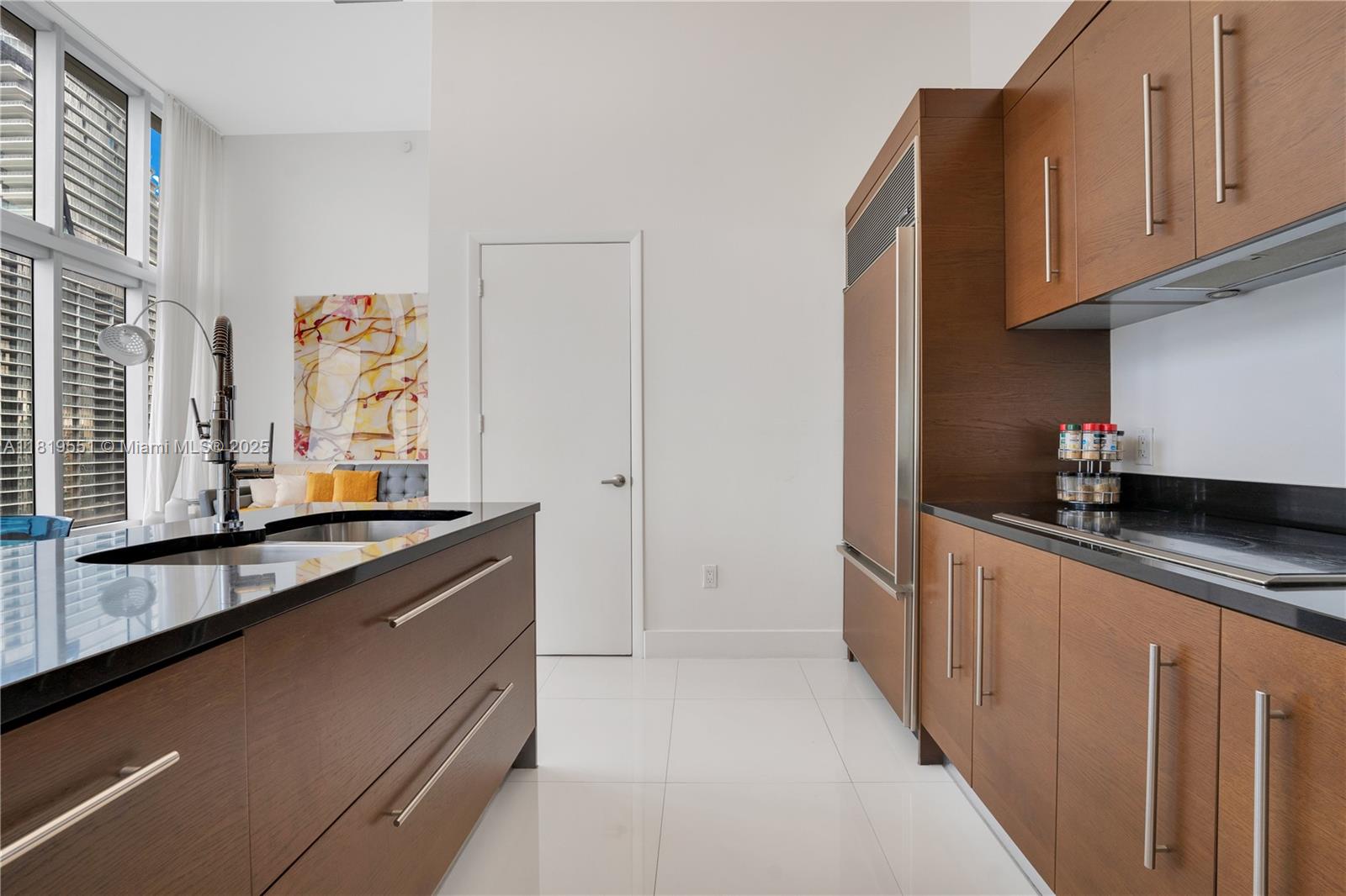 485 Brickell Avenue, Unit 4004 Miami, FL 33131 - Photo 4 of 22 a kitchen with granite countertop a sink and cabinets