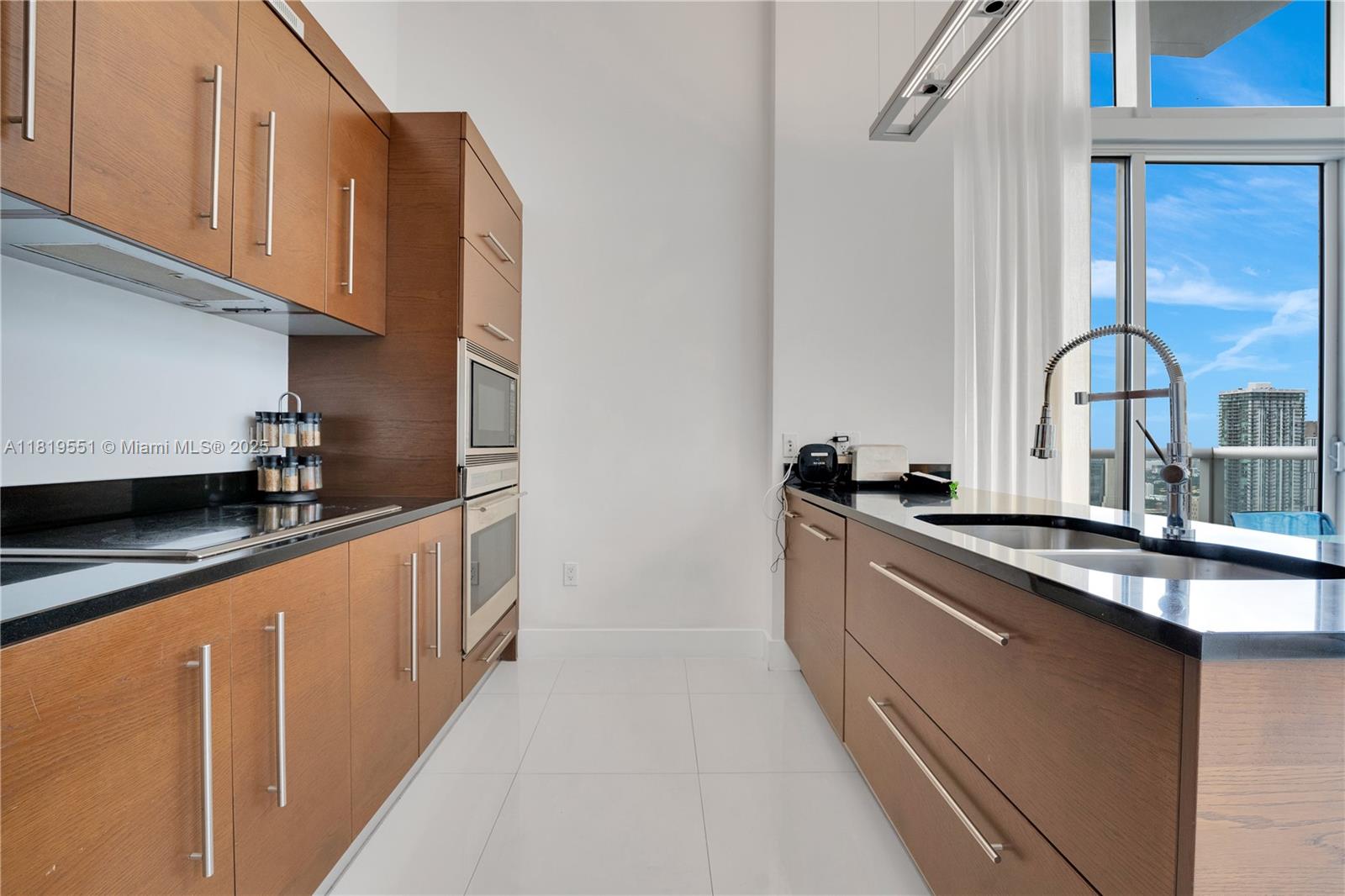 485 Brickell Avenue, Unit 4004 Miami, FL 33131 - Photo 6 of 22 a kitchen with stainless steel appliances granite countertop a sink and cabinets