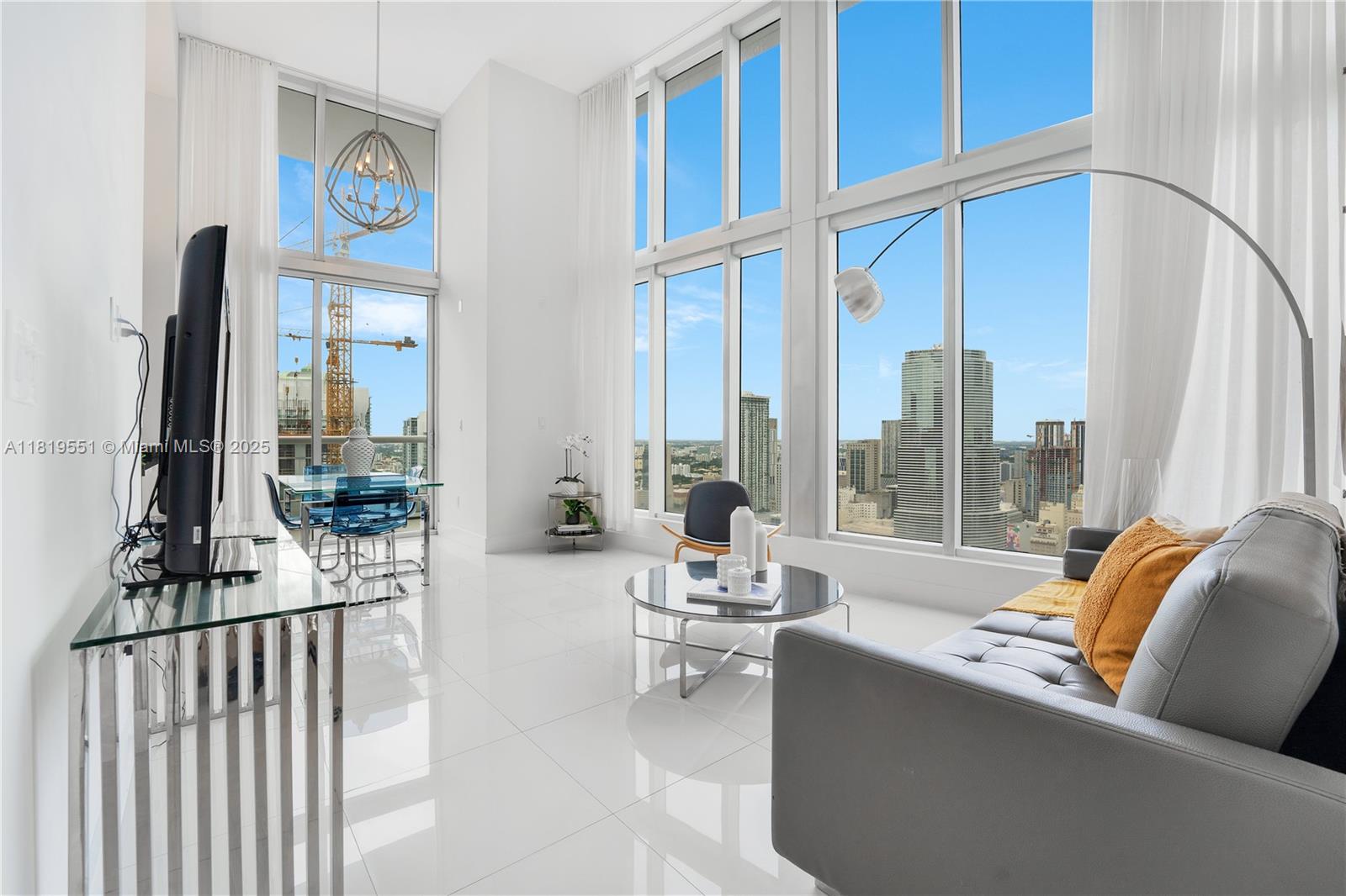 485 Brickell Avenue, Unit 4004 Miami, FL 33131 - Photo 8 of 22 a living room with furniture and a large window