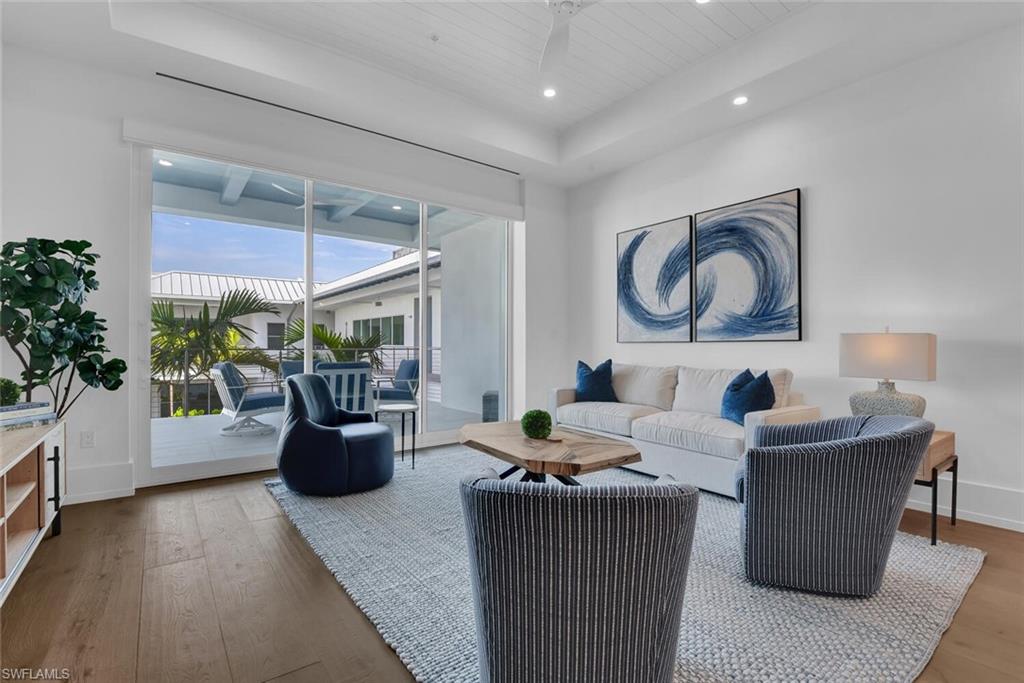201 8th Street South, Unit 310 Naples, FL 34102 - Photo 11 of 39 a living room with fireplace furniture and a potted plant