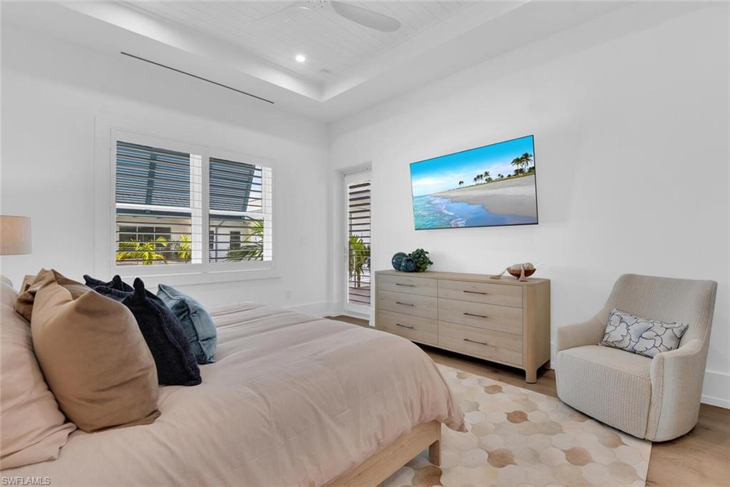 201 8th Street South, Unit 310 Naples, FL 34102 - Photo 15 of 39 a bedroom with furniture and window