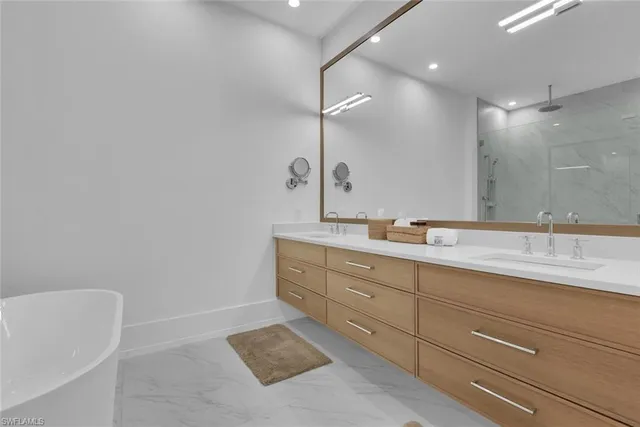 a bathroom with a tub sink and mirror