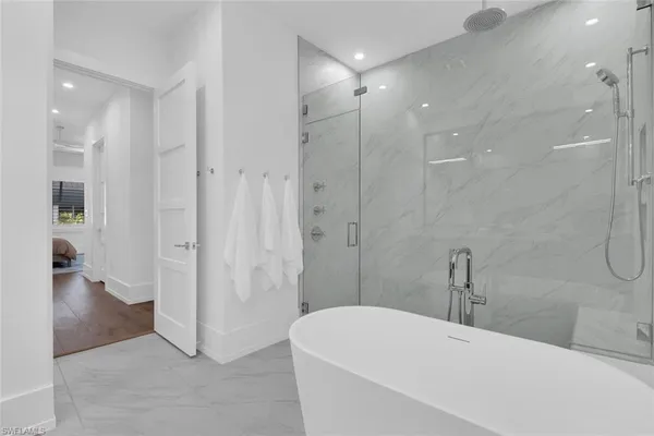 a bathroom with a bathtub and a shower