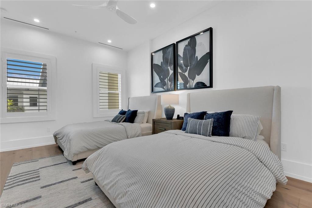 201 8th Street South, Unit 310 Naples, FL 34102 - Photo 21 of 39 a bedroom with two beds and a large window