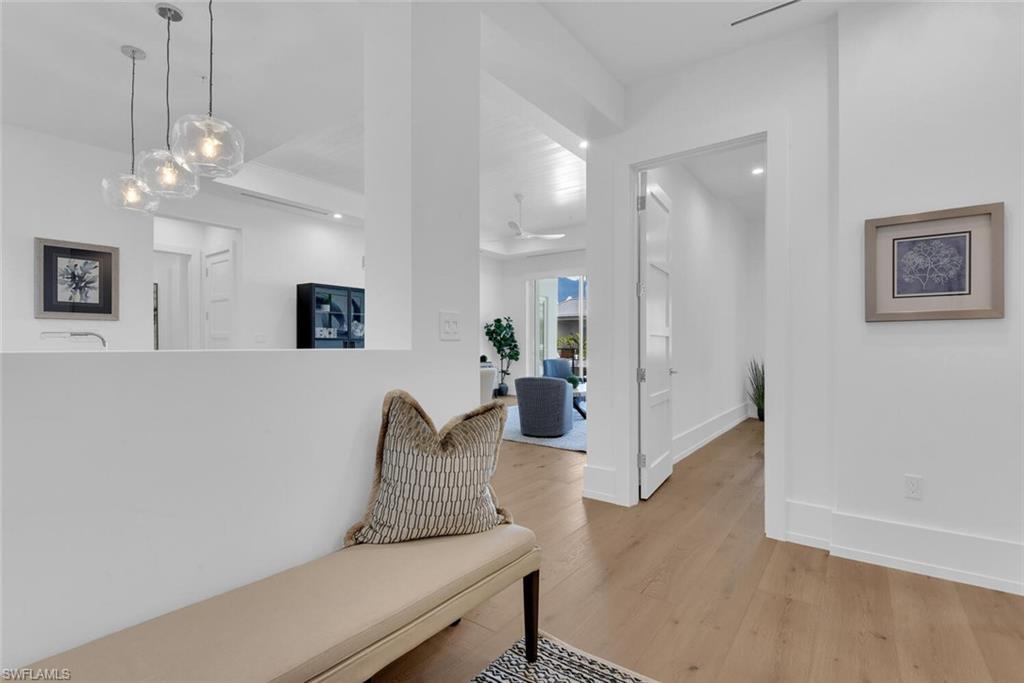 201 8th Street South, Unit 310 Naples, FL 34102 - Photo 3 of 39 a living room with furniture and a chandelier