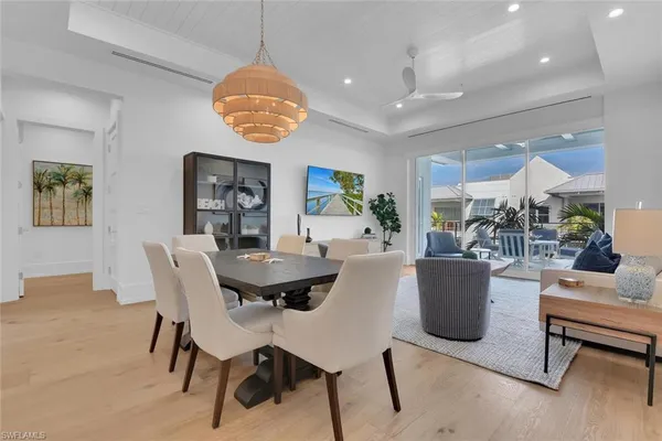 a view of a dining room with furniture and chandelier