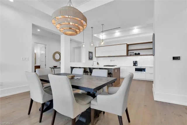 a view of a dining room with furniture and chandelier