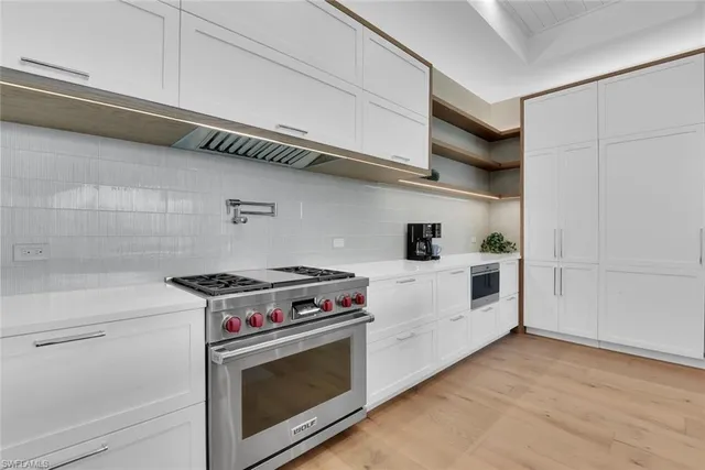 a white stove top oven sitting inside of a kitchen