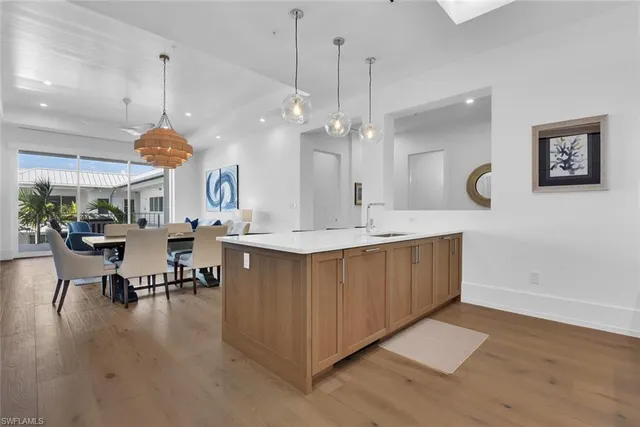 a large kitchen with a table and chairs in it