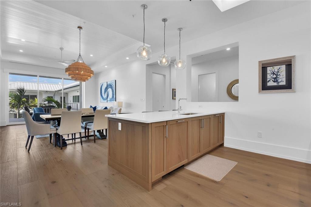 201 8th Street South, Unit 310 Naples, FL 34102 - Photo 10 of 39 a large kitchen with a table and chairs in it