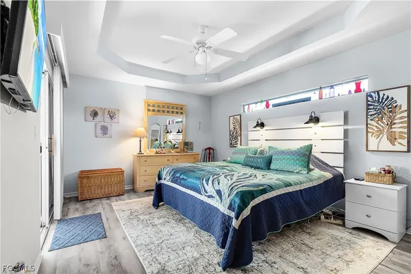 a bedroom with a bed couch and dresser