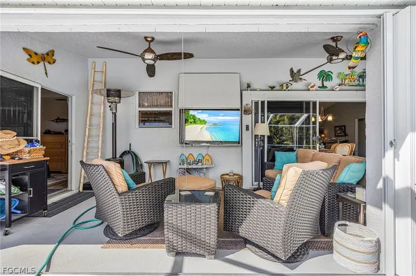 a dining room with furniture and a floor to ceiling window